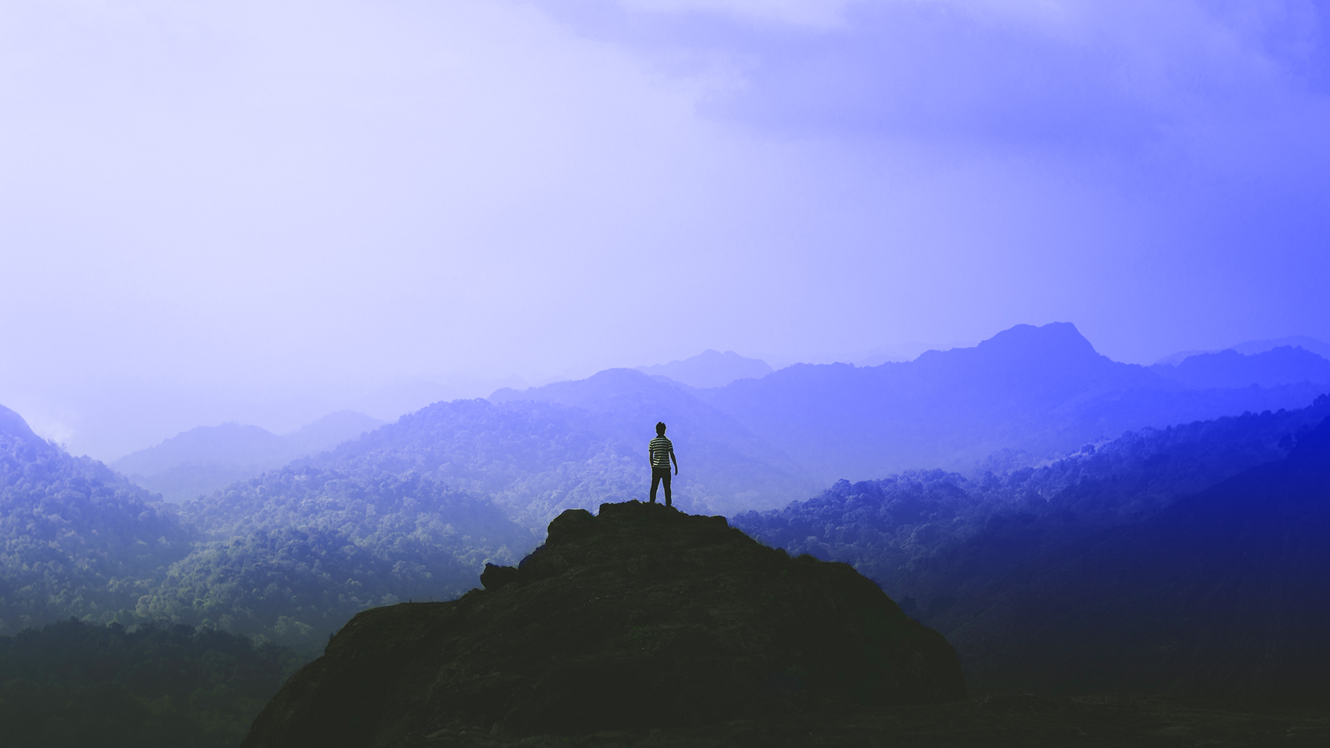 Image of a person standing on a mountain top